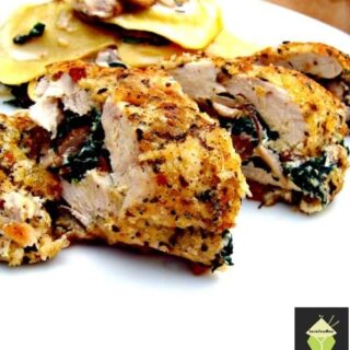 Herb Crusted Stuffed Chicken, a delicious juicy baked chicken breast stuffed with cream cheese and spinach and coated in crispy breadcrumbs.