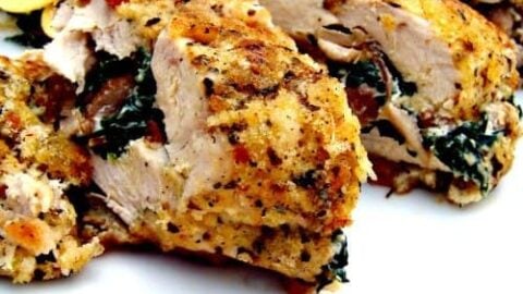 Herb Crusted Stuffed Chicken, a delicious juicy baked chicken breast stuffed with cream cheese and spinach and coated in crispy breadcrumbs.