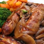 British Toad in the Hole! It's a delicious easy dinner, with sausages baked in Yorkshire pudding (a.k.a. pop overs). Goes great with some homemade onion gravy. Always a hit with the whole family, easy to make and oh so good!