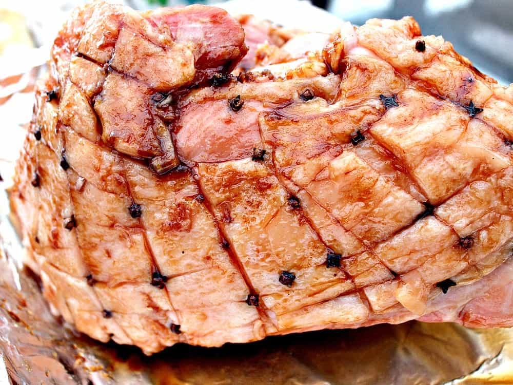 Honey Glazed Ham. Showing how to put the cloves in to the ham. Honey Glazed Ham. Showing how to put the cloves in to the ham.
