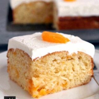 Mandarin Cake. This is a delicious soft and moist cake with juicy mandarins running throughout .