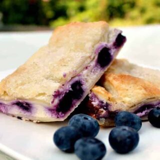 Blueberry Crescent Roll Cheesecake Bars. An incredibly easy recipe with cream cheese and blueberry filling sandwiched between layers of pastry. This tastes amazing!