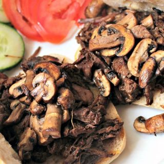 Sweet and Spicy Pulled Beef. Slow cooked tender beef in a delicious sauce, simply served on a warm ciabatta roll with sauteed mushrooms, makes for a perfect meal!