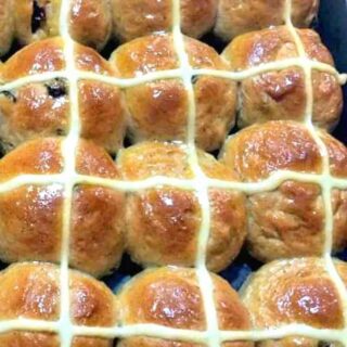 Hot Cross Buns are a lovely soft, spiced sweet roll, and traditionally made at Easter time, simply spilt apart and spread with butter and jam. They're lovely eaten warm from the oven or split and toasted. Nowadays, these are enjoyed all year round! Very easy to make and freezer friendly.