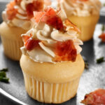 French Toast Cupcakes! These are wonderful soft and moist little cakes with a vanilla and maple flavor, frosted with maple cream and then topped off with some candied bacon. A super easy recipe and always so popular as a breakfast, dessert or for parties!