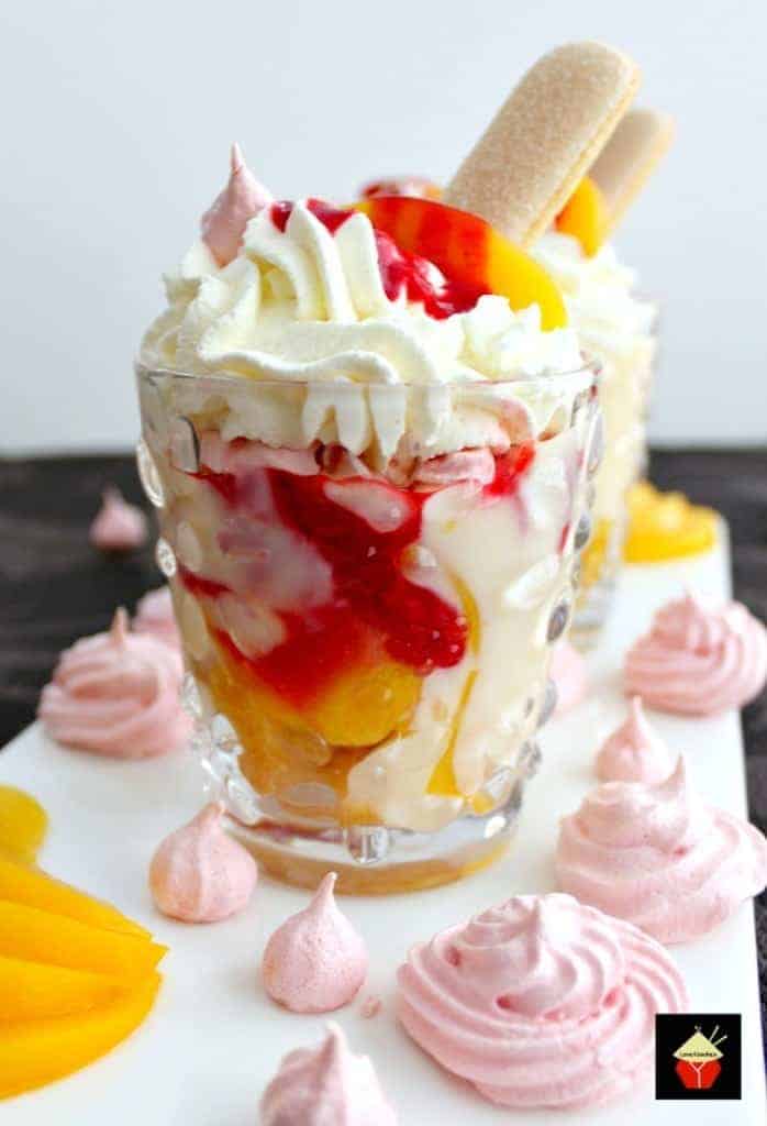 Amazing Peach Melba Trifle! Dreamy layers of Lady Fingers, creamy vanilla pudding, peaches, raspberry sauce, whipped cream and meringue cookies. It can't get better than this! | Lovefoodies.com