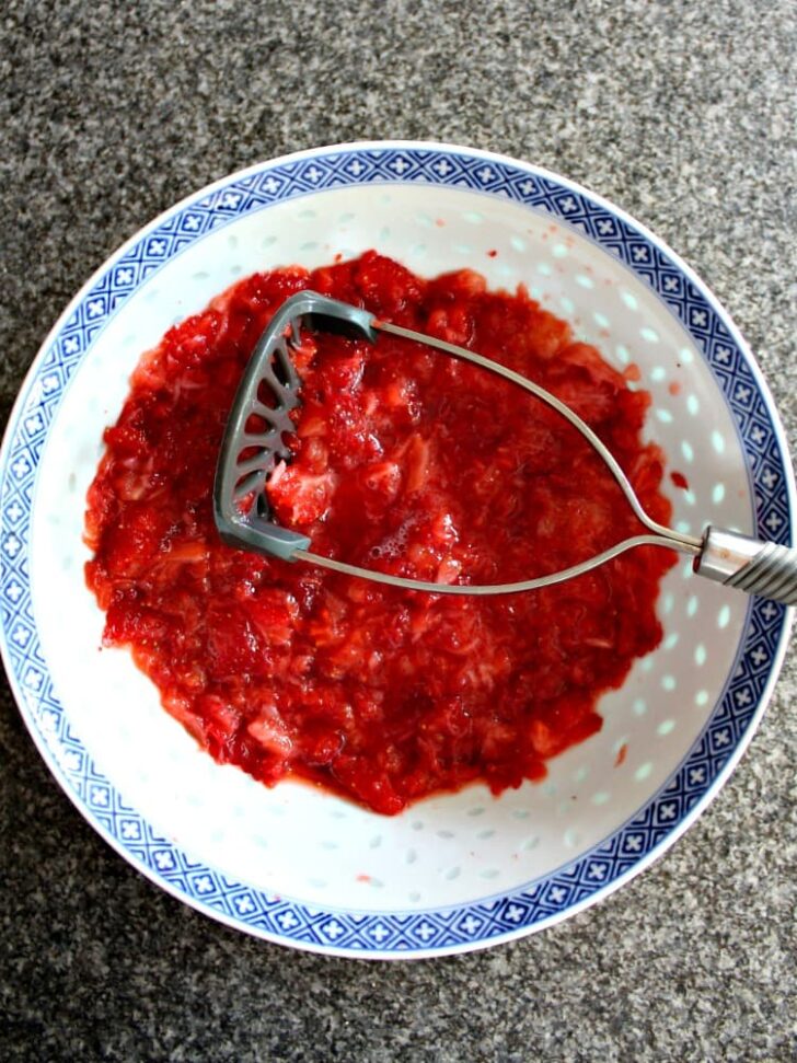 Mash strawberries for cheesecake filling Mash strawberries for cheesecake filling