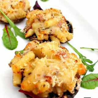 Mac N Cheese Stuffed Mushrooms is so delicious! Easy to make and great for parties or as an appetizer. Baked mushrooms stuffed with a creamy macaroni and cheese filling with bacon too!