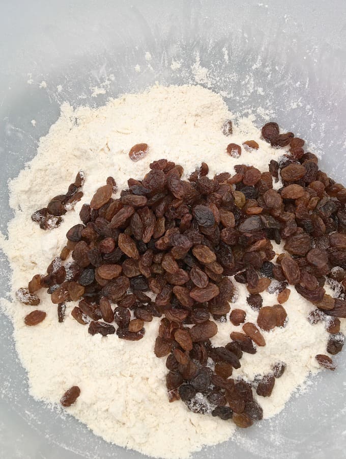Adding dried fruit to flour and butter Adding dried fruit to flour and butter