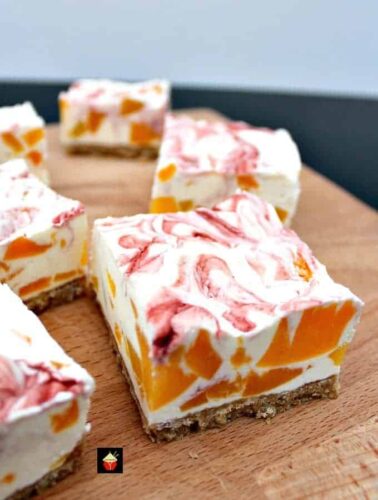 Easy Peach Cheesecake With Raspberry Swirl, a delicious no-bake creamy dessert bursting with juicy peaches. Quick and easy to make and great for parties too!