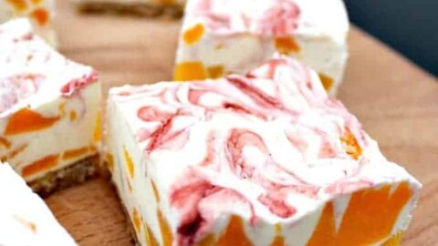 Easy Peach Cheesecake With Raspberry Swirl, a delicious no-bake creamy dessert bursting with juicy peaches. Quick and easy to make and great for parties too!