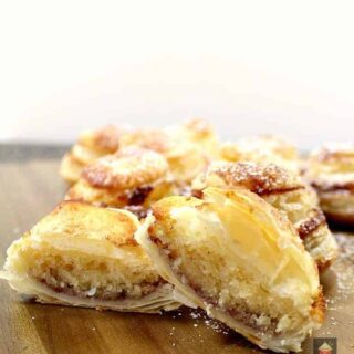 Mini Frangipane tarts are delicious almond cake filled mini tarts in a crispy puff pastry case. Delicious served warm from the oven or cooled with a blob of ice cream or fresh whipped cream!
