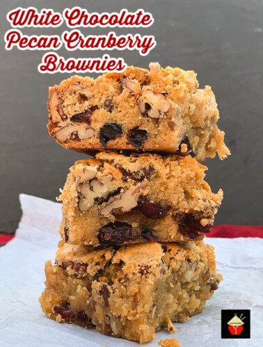 White Chocolate and Pecan Cranberry Brownies (Blondies). Deliciously gooey and decadent white chocolate brownies with pecan nuts and cranberries for a festive twist. Crispy outer layer, dense and fudge inside, just as a brownie should be. 