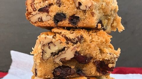 White Chocolate and Pecan Cranberry Brownies (Blondies). Deliciously gooey and decadent white chocolate brownies with pecan nuts and cranberries for a festive twist. Crispy outer layer, dense and fudge inside, just as a brownie should be.