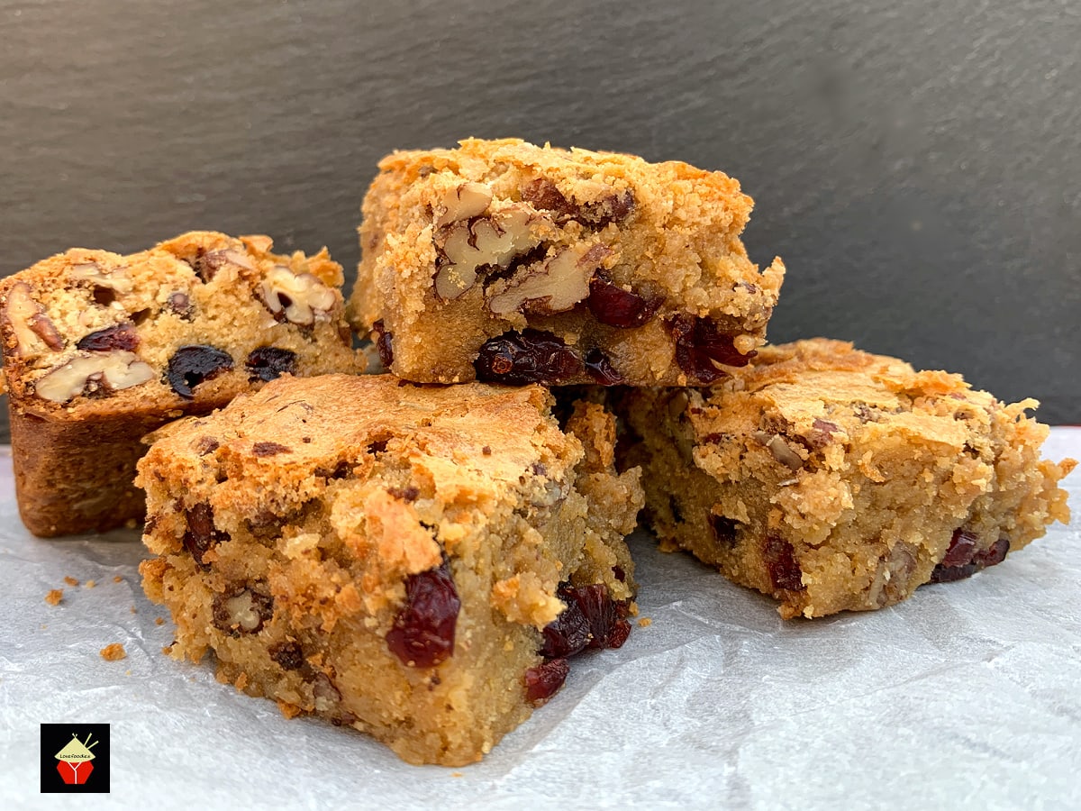 White Chocolate and Pecan Cranberry Brownies (Blondies). Deliciously gooey and decadent white chocolate brownies with pecan nuts and cranberries for a festive twist. Crispy outer layer, dense and fudgy inside, just as a brownie should be.