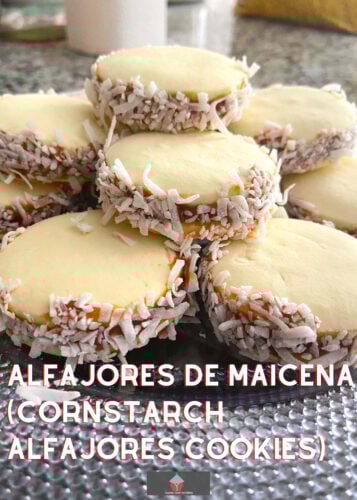 Alfajores De Maicena, delicious melt-in-the-mouth buttery shortbread cookies from Argentina, made with cornstarch and filled with Dulce de Leche then rolled in coconut.