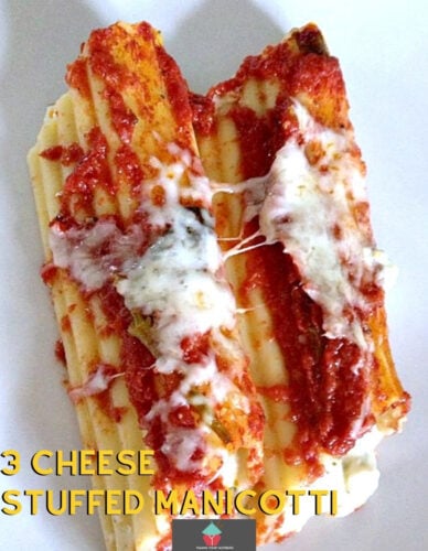 Three Cheese Stuffed Manicotti - A great tasting easy recipe and freezer friendly too! Delicious pasta stuffed with cheese and baked in a homemade tomato sauce