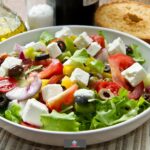 This Simple Greek Salad is full of flavor. Cucumber, tomatoes, lettuce, feta cheese, olives and onion combined with a delicious lemon and herb salad dressing.
