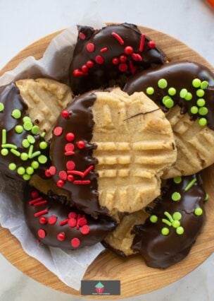 Chocolate Dipped Peanut Butter Cookies Classic peanut butter cookies dipped in chocolate and covered in sprinkles are delicious with a cold glass of milk. Creamy, crunchy and full of flavor. Easy recipe too!
