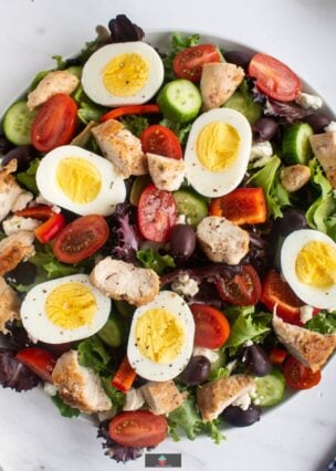 Greek Chicken Salad is full of flavor, tender juicy chicken breasts, combined with a variety of salads, olives, and feta cheese, with a generous coating of delicious Greek salad dressing. Easy to make and a very popular salad recipe.