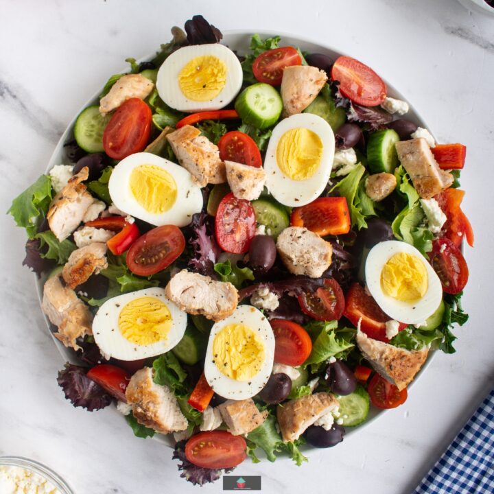 Greek Chicken Salad is full of flavor, tender juicy chicken breasts, combined with a variety of salads, olives, and feta cheese, with a generous coating of delicious Greek salad dressing. Easy to make and a very popular salad recipe.